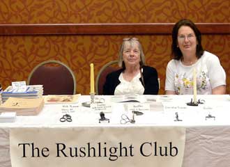 Rushlight Club show table with lighting items for display and discussion