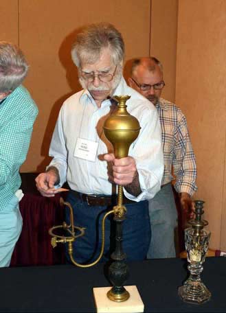 Photo of Heinz Baumann holding a vapor lamp