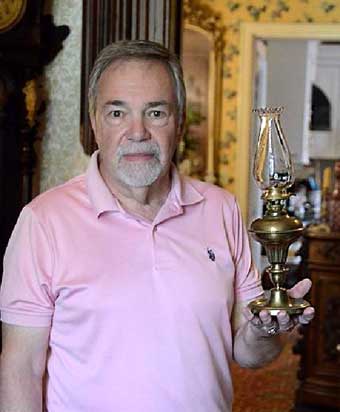 Bill Soeffing holding small solar Lamp converted to kerosene